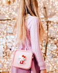 A girl wears a pink Hello Kitty silicone bag.