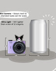 A purple Kuromi mini camera shown next to a standard soda can for size comparison.