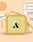 Yellow silicone bag with a bee design and adjustable strap.
