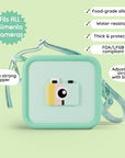 A green silicone camera bag with a camera design and adjustable strap.