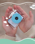 Child holding the kiimento Model A Cinnamoroll kids' digital camera in both hands, showing its ultra-compact design.