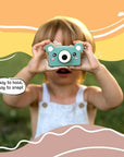 Young child using kiimento Model C Bear kids digital camera outdoors, easy to hold and snap photos.