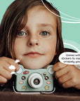 Young girl holding Kidamento Model C Bear kids digital camera customized with fun stickers.