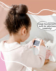 Young girl using the Kidamento Meowie the Cat digital camera with a large touchscreen, capturing creative photos indoors with her toy.