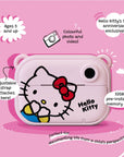 Front view of the Kidamento Hello Kitty Model P kids digital camera, featuring Hello Kitty’s face on a pastel pink body. Image highlights include adjustable strap attachment, 32GB memory, full-color photo and video capability, and a 50th anniversary limited-edition design. Suitable for ages 5 and up.