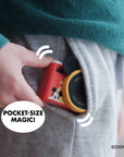 Mickey Mouse mini camera with red body and yellow lens, tucked into a pocket.