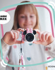 Minnie Mouse mini camera with pink bow and ears holding by a girl.