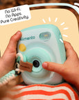 Mint Print Pro Camera held by hands with a hand strap.