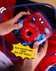 A Spider-Man themed instant print camera held by kid's hands.