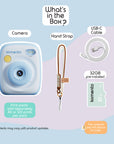 Sky blue instant print camera with USB-C cable, hand strap, and 32GB card.