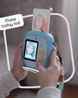 Sky blue instant print camera with a photo coming out of the top.