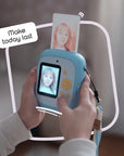 Sky blue instant print camera with a photo coming out of the top.