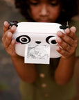 Child holding kiimento Panda Print Camera Model P printing a photo outdoors – kids instant print camera