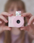 Girl holding kiimento Sanrio Hello Kitty Mini Camera Model A outdoors – pink Hello Kitty mini kids camera