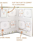 An open activity book with prompts for challenges, picture frames, and space to write or draw.