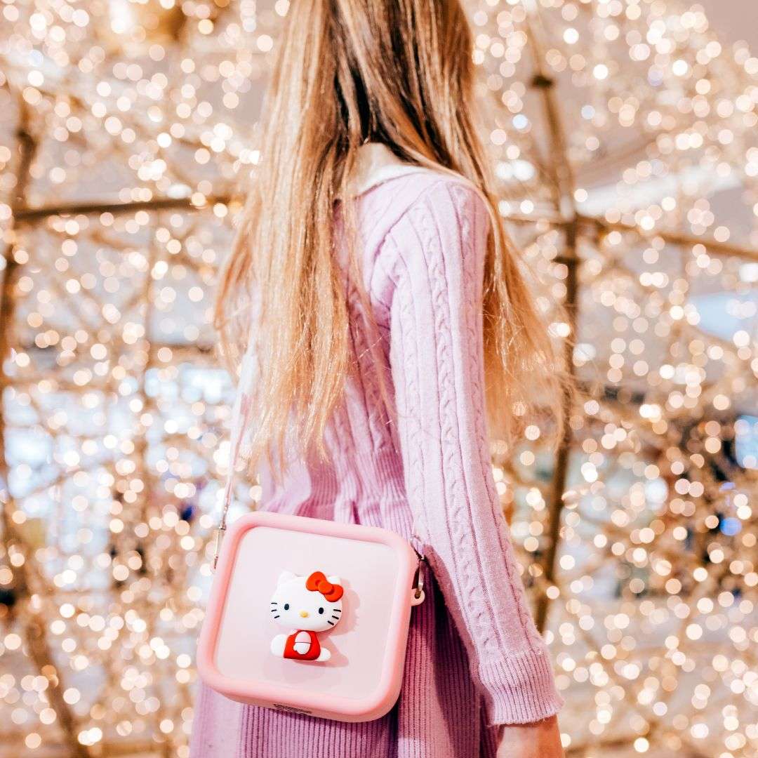 A girl wears a pink Hello Kitty silicone bag.