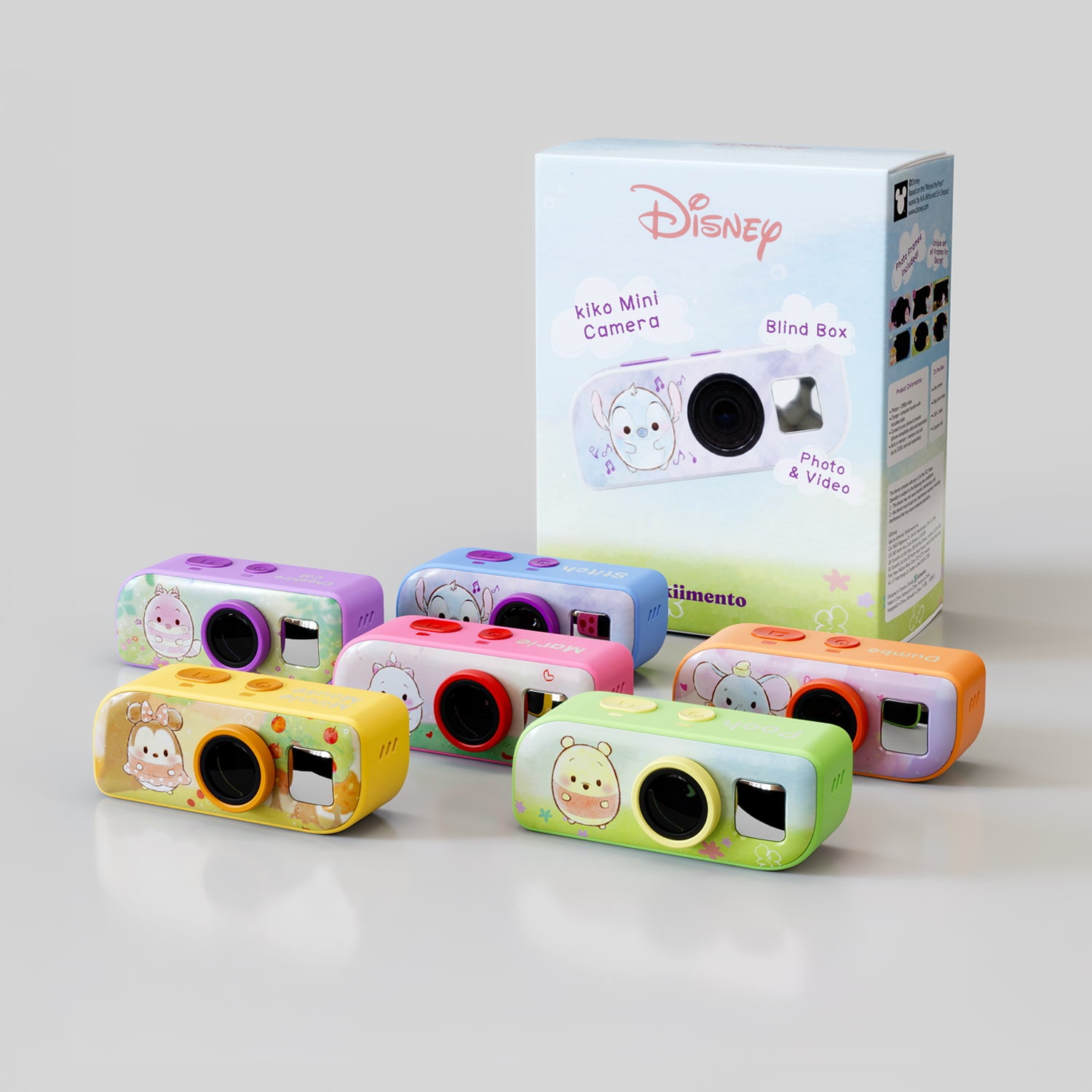 All six kiko Mini Camera Disney blind box designs (Cheshire Cat, Stitch, Marie, Dumbo, Winnie the Pooh, Minnie Mouse) grouped together in front of the retail packaging, showing each camera's color and character artwork.