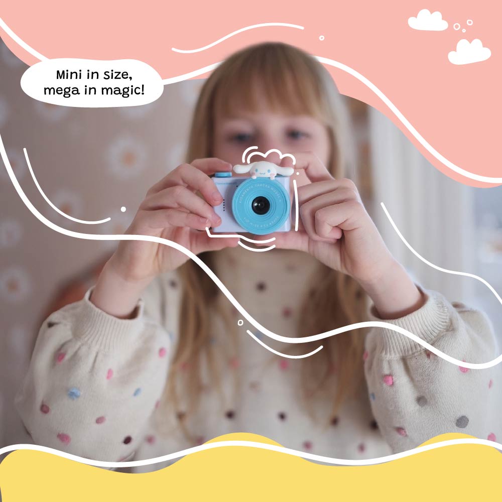 A child holding and aiming the Kidamento Model A Cinnamoroll kids' digital camera, with playful graphic overlays and the caption “Mini in size, mega in magic!”.