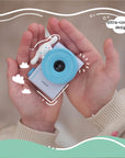 Child holding the Kidamento Model A Cinnamoroll kids' digital camera in both hands, showing its ultra-compact design.