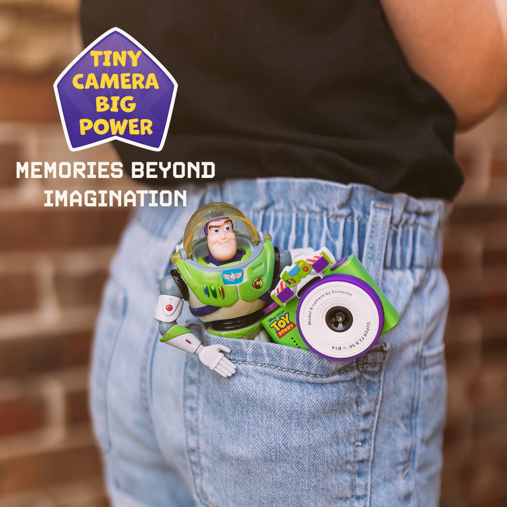 Digital Buzz Lightyear mini camera with green and purple body, tucked into a pocket for size and use reference.