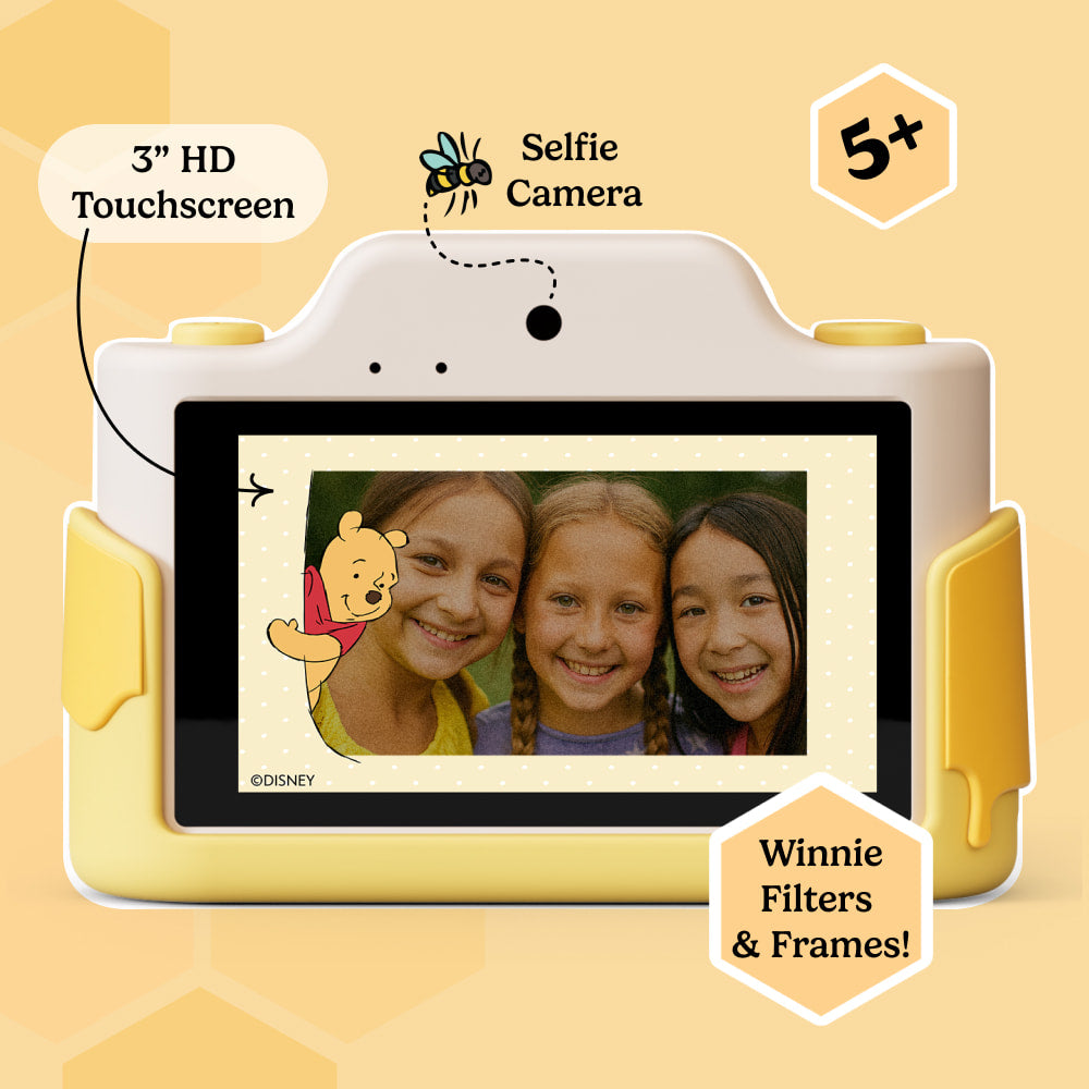 Kids' digital camera with 3-inch HD touchscreen displaying a photo with Winnie the Pooh frame, selfie camera, and Winnie filters & frames. Recommended for ages 5+