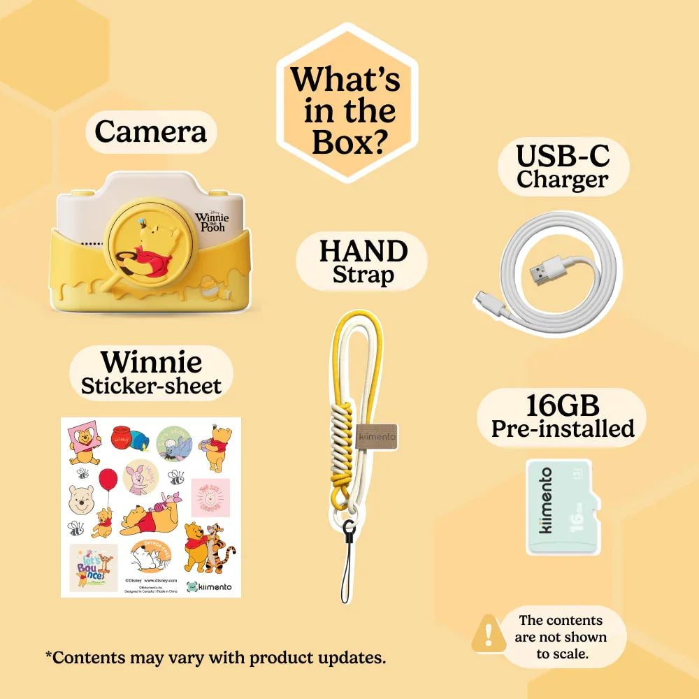 Contents of the Winnie the Pooh digital camera box including camera, USB-C charger, hand strap, 16GB pre-installed memory card, and Winnie the Pooh sticker sheet.