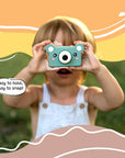 Young child using Kidamento Model C Bear kids digital camera outdoors, easy to hold and snap photos.