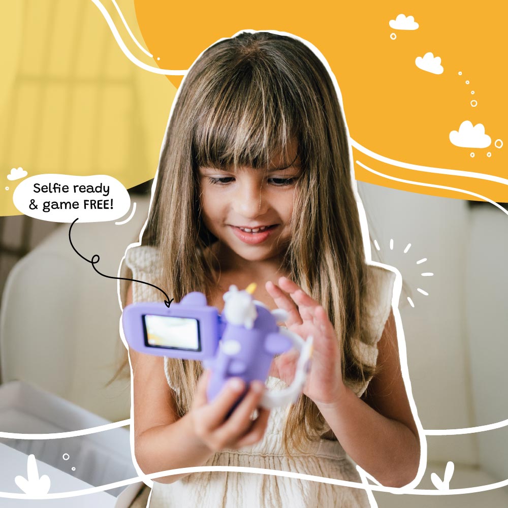 Young girl using the Kidamento Model V unicorn kids digital camera indoors. Features visible include flip screen, selfie mode, and fun unicorn airplane design—perfect screen-free toy for ages 3 to 9.