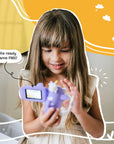 Young girl using the Kidamento Model V unicorn kids digital camera indoors. Features visible include flip screen, selfie mode, and fun unicorn airplane design—perfect screen-free toy for ages 3 to 9.