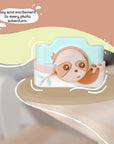 Kidamento Model K Zippy the Sloth kids digital camera displayed on a wooden table, highlighting its playful and colorful sloth design