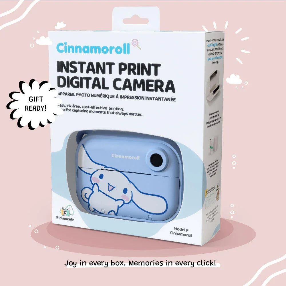 Product packaging of the Kidamento Model P Cinnamoroll instant print digital camera, showcasing the blue Cinnamoroll-themed camera inside a white gift-ready box with bold text and soft pink background. Tagline reads: “Joy in every box. Memories in every click!”