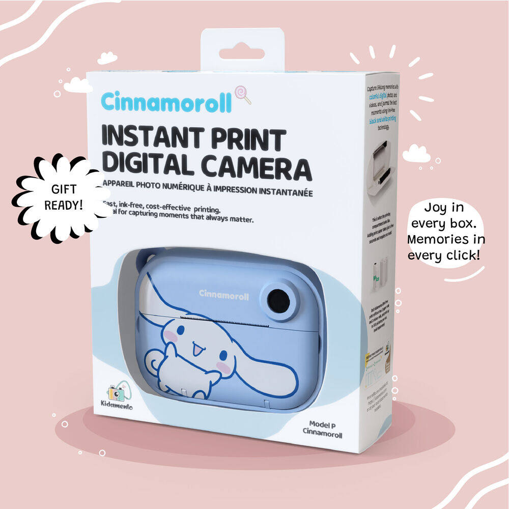 Product packaging of the Kidamento Model P Cinnamoroll instant print digital camera, showcasing the blue Cinnamoroll-themed camera inside a white gift-ready box with bold text and soft pink background. Tagline reads: “Joy in every box. Memories in every click!”