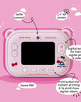Back view of the Kidamento Hello Kitty Model P digital camera for kids, showcasing a 2.4-inch IPS screen, selfie camera, and clearly labeled buttons. Features include a digital shutter button for photo and video capture, a print button for instant printing and album reprints, and Hello Kitty-themed decorations on a pastel pink camera body.
