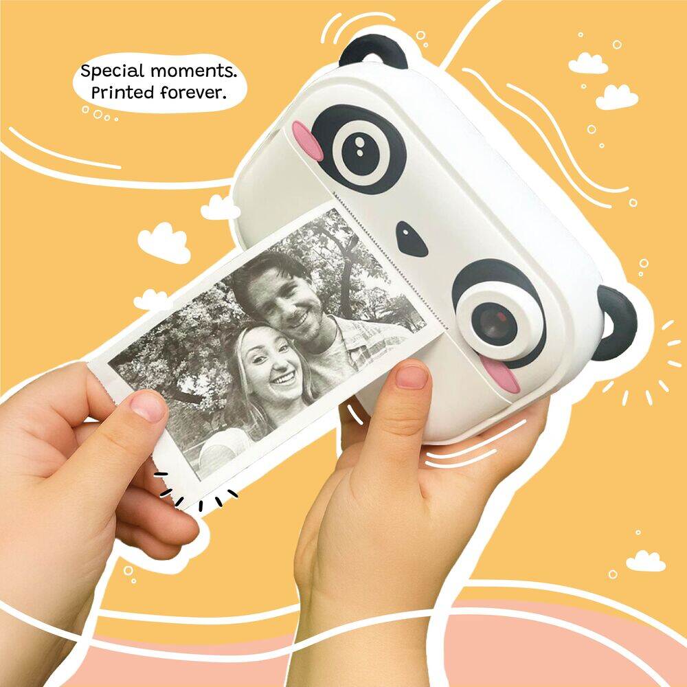 Hands holding Kidamento Model P Panda camera printing a black and white photo instantly, with playful orange background.