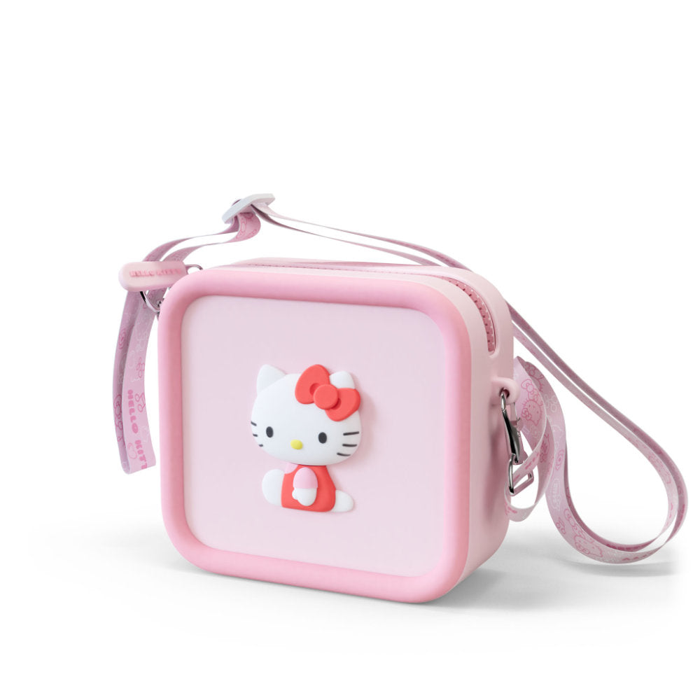 A pink square silicone bag with a 3D Hello Kitty design and a patterned strap.