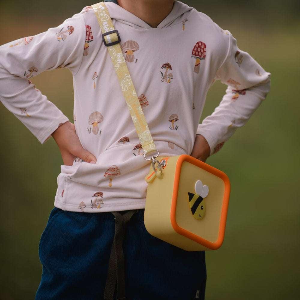 Little Bee silicone bag with a bee design and yellow strap.