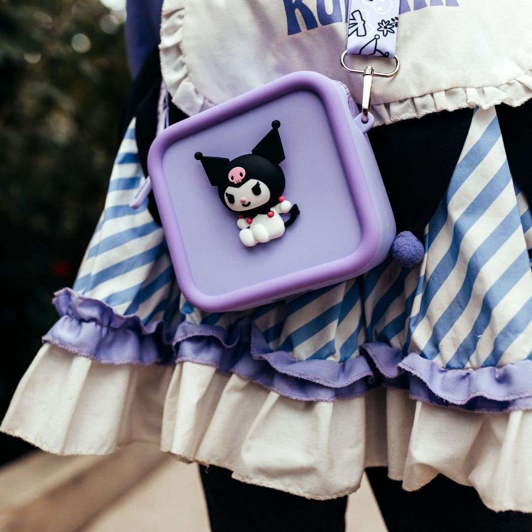 A purple silicone bag featuring a 3D Kuromi character, worn over a striped dress.