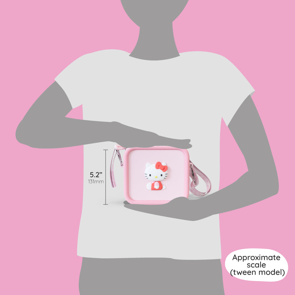 A pink silicone Hello Kitty bag with a shoulder strap shown for scale against a person.