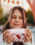 Girl using kiimento Sanrio Hello Kitty Print Camera Model P – pink Hello Kitty kids instant print camera