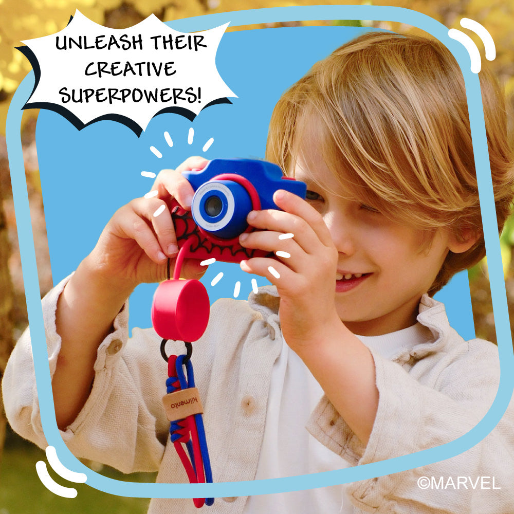 A child holds a blue and red Spider-Man digital camera.