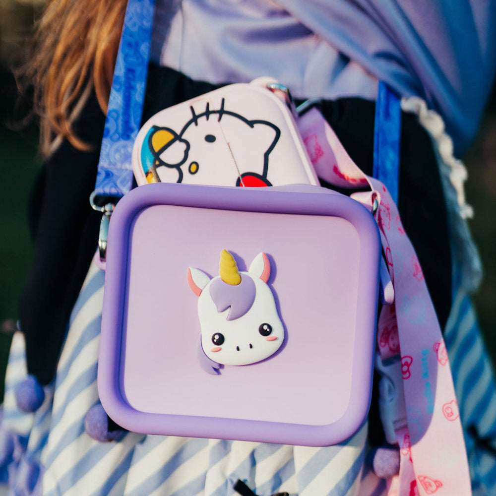 Purple silicone bag with a unicorn design and a pink Hello Kitty bag.